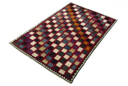 Corner detail of 2000s Persian Gabbeh rug showing border pattern and Wool pile