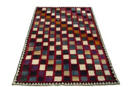 Surface texture of 2000s Persian Gabbeh rug with natural Wool and intricate pattern