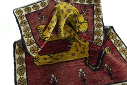 Corner detail of 2000s Persian Gabbeh rug showing border pattern and Wool pile