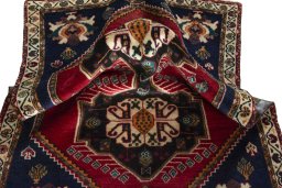 Corner detail of 2000s Persian Gabbeh rug showing border pattern and Wool pile