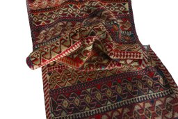 Corner detail of 2000s Persian Gabbeh rug showing border pattern and Wool pile