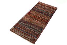 Corner detail of 2000s Persian Gabbeh rug showing border pattern and Wool pile