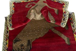 Corner detail of 2000s Persian Gabbeh rug showing border pattern and Wool pile