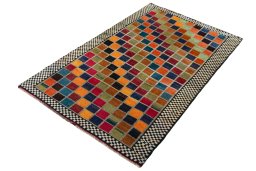Corner detail of 2000s Persian Gabbeh rug showing border pattern and Wool pile