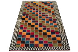 Surface texture of 2000s Persian Gabbeh rug with natural Wool and intricate pattern