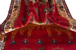 Corner detail of 2000s Persian Gabbeh rug showing border pattern and Wool pile