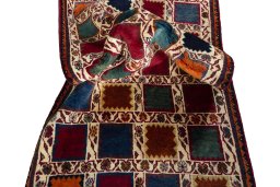 Corner detail of 2000s Persian Gabbeh rug showing border pattern and Wool pile