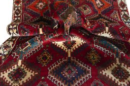 Corner detail of 2000s Persian Gabbeh rug showing border pattern and Wool pile