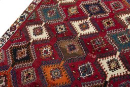 Backside of handmade 2000s Persian Gabbeh rug showing knot structure and weave density
