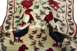 Corner detail of 2000s Persian Gabbeh rug showing border pattern and Wool pile