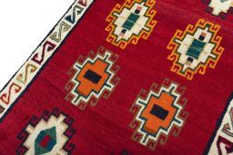 Backside of handmade 2000s Persian Gabbeh rug showing knot structure and weave density