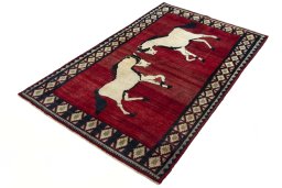Corner detail of 2000s Persian Gabbeh rug showing border pattern and Wool pile