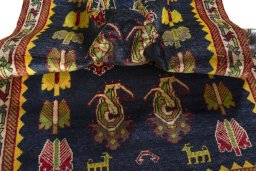 Corner detail of 2000s Persian Gabbeh rug showing border pattern and Wool pile