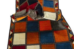 Corner detail of 2000s Persian Gabbeh rug showing border pattern and Wool pile