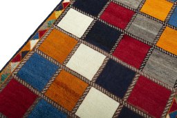 Backside of handmade 2000s Persian Gabbeh rug showing knot structure and weave density