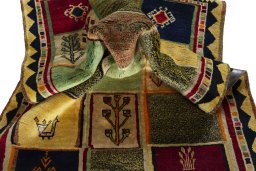 Corner detail of 2000s Persian Gabbeh rug showing border pattern and Wool pile