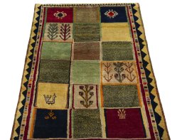 Surface texture of 2000s Persian Gabbeh rug with natural Wool and intricate pattern