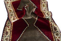 Corner detail of 2000s Persian Gabbeh rug showing border pattern and Wool pile