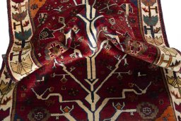 Corner detail of 2000s Persian Gabbeh rug showing border pattern and Wool pile