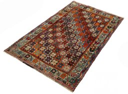 Corner detail of 1970s Persian Gabbeh rug showing border pattern and Wool pile