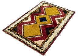 Corner detail of 2000s Persian Gabbeh rug showing border pattern and Wool pile