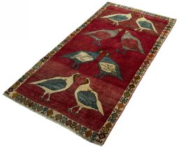 Corner detail of 2000s Persian Gabbeh rug showing border pattern and Wool pile