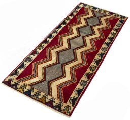 Corner detail of 2000s Persian Gabbeh rug showing border pattern and Wool pile