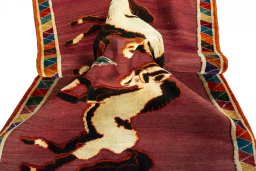 Corner detail of 2000s Persian Gabbeh rug showing border pattern and Wool pile