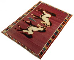 Corner detail of 2000s Persian Gabbeh rug showing border pattern and Wool pile