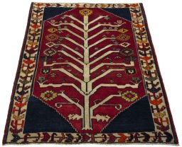 Surface texture of 2000s Persian Gabbeh rug with natural Wool and intricate pattern