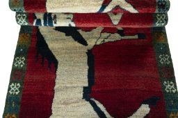 Full view of 2000s Persian Gabbeh rug from Iran / Persia, 208 × 88 cm in Red tones