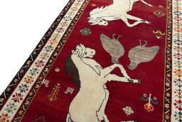Backside of handmade 2000s Persian Gabbeh rug showing knot structure and weave density
