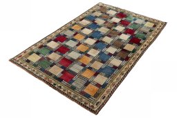 Corner detail of 2000s Persian Gabbeh rug showing border pattern and Wool pile