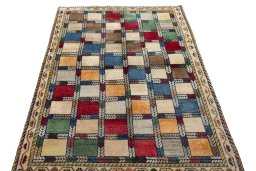 Surface texture of 2000s Persian Gabbeh rug with natural Wool and intricate pattern