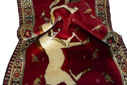 Corner detail of 2000s Persian Gabbeh rug showing border pattern and Wool pile