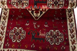 Corner detail of 2000s Persian Gabbeh rug showing border pattern and Wool pile