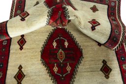 Corner detail of 2000s Persian Gabbeh rug showing border pattern and Wool pile