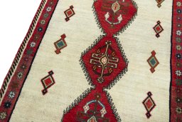 Backside of handmade 2000s Persian Gabbeh rug showing knot structure and weave density