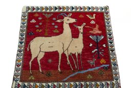 Surface texture of 2000s Persian Gabbeh rug with natural Wool and intricate pattern