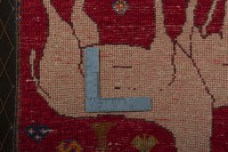 Backside of handmade 2000s Persian Gabbeh rug showing knot structure and weave density