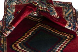 Corner detail of 2000s Persian Gabbeh rug showing border pattern and Wool pile