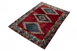 Corner detail of 2000s Persian Gabbeh rug showing border pattern and Wool pile