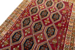 Backside of handmade 2000s Persian Gabbeh rug showing knot structure and weave density
