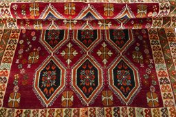 Full view of 2000s Persian Gabbeh rug from Iran / Persia, 243 × 157 cm in Red tones