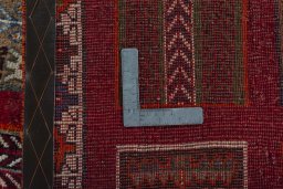 Corner detail of 2000s Persian Gabbeh rug showing border pattern and Wool pile