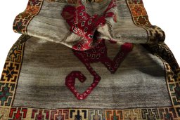 Corner detail of 2000s Persian Gabbeh rug showing border pattern and Wool pile