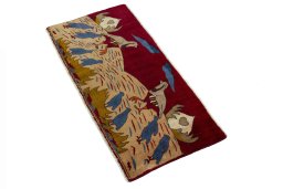 Corner detail of 2000s Persian Gabbeh rug showing border pattern and Wool pile