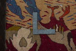Backside of handmade 2000s Persian Gabbeh rug showing knot structure and weave density