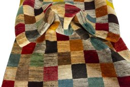 Corner detail of 2000s Persian Gabbeh rug showing border pattern and Wool pile
