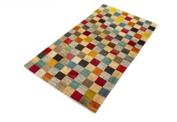 Corner detail of 2000s Persian Gabbeh rug showing border pattern and Wool pile